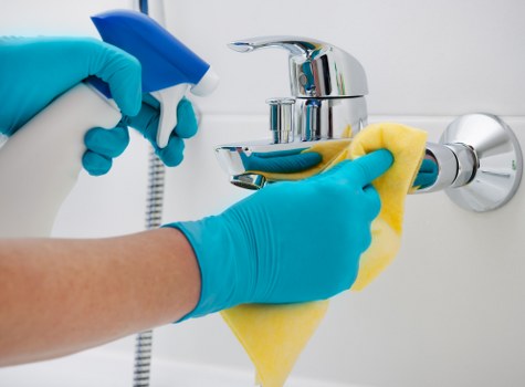 Technician applying safe cleaning procedures to a carpeted area
